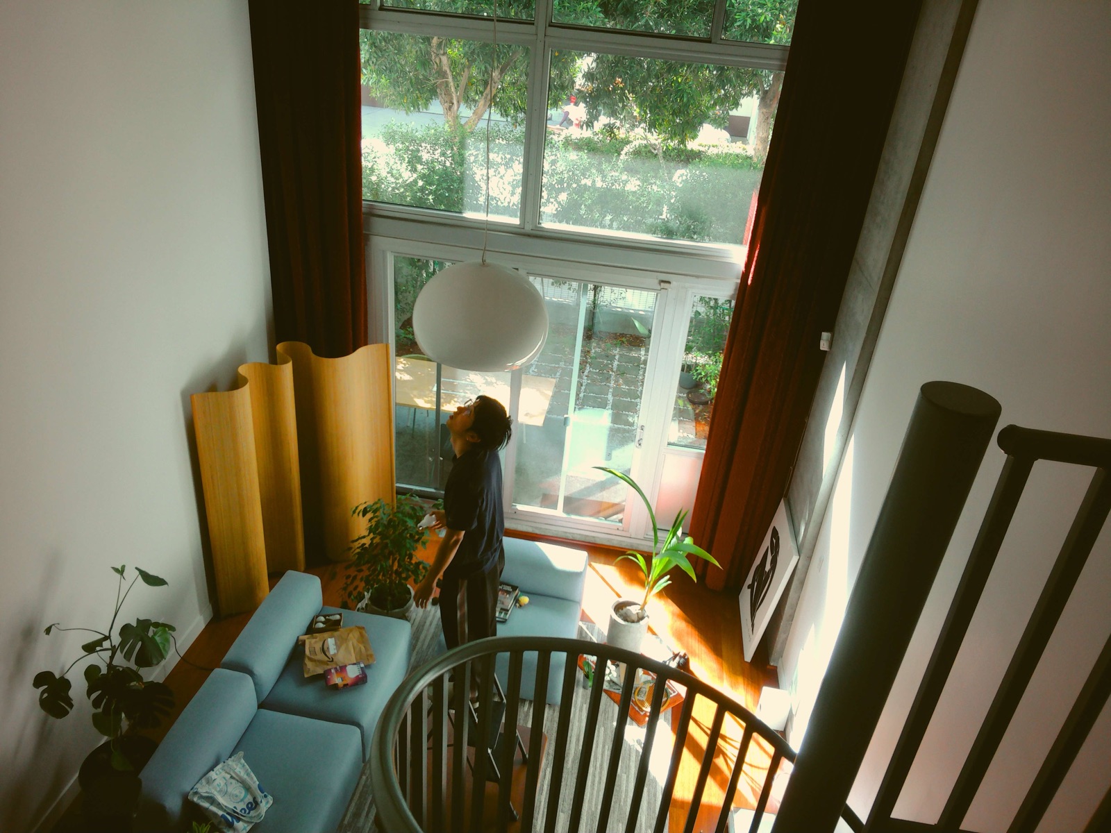 Eric standing in a sunlit living room, looking up